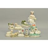 A VICTORIAN STAFFORDSHIRE POTTERY FIGURE OF A LADY SEATED WITH A LAMB, repair around her neck, on an