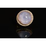 A VICTORIAN GOLD STAR SAPPHIRE AND WHITE STONE ROUND SMALL CIRCULAR BROOCH, a light purplish-blue