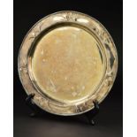 AN EDWARDIAN GUILD OF HANDICRAFTS SILVER TRAY, of circular form, the rim with a border of embossed
