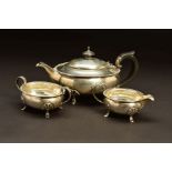 A GEORGE V SILVER THREE PIECE BACHELOR'S TEASET, of oval form, egg and tongue rims, on four cabriole