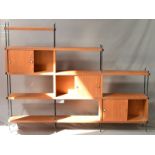 A 1970’S TEAK MODULAR SHELVING ROOM DIVIDER, of asymmetric design comprising an arrangement of