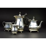 A GEORGE V SILVER FOUR PIECE TEA SERVICE, of octagonal baluster form, 'S' scroll handles, ebony