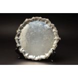 A VICTORIAN SILVER SALVER, of circular form, with foliate cast wavy rim above pie crust border,