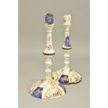 A PAIR OF GEORGIAN BILSTON ENAMEL CANDLESTICKS, both lacking drip pans, knopped stems and domed wavy