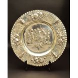 A LATE 19TH/EARLY 20TH CENTURY HANAU SILVER CHARGER, crimped rim, the border embossed with