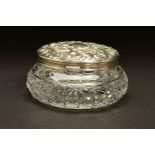 AN ELIZABETH II SILVER TOPPED GLASS DRESSING TABLE/POWDER BOWL, of circular form, foliate repousse