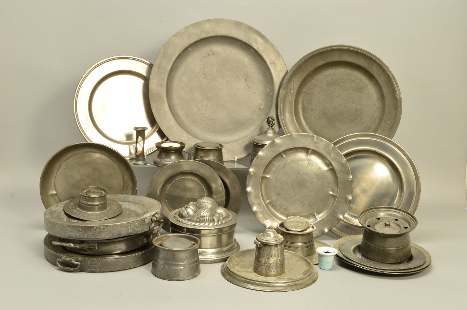 A BOX OF PEWTER PLATES, INKWELLS AND WARMING DISHES, etc, mostly Victorian, diameter of largest