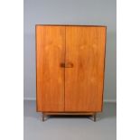 IB KOFOD LARSEN, FOR GPLAN DANISH RANGE, a teak 1960's triple door wardrobe, with double bifold