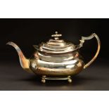 A GEORGE III SILVER TEAPOT, of bellied oblong form, foliate finial lacking insulator collar,