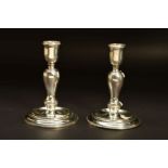 A PAIR OF ELIZABETH II SILVER CANDLESTICKS OF GEORGE I STYLE, urn shaped holders on inverted