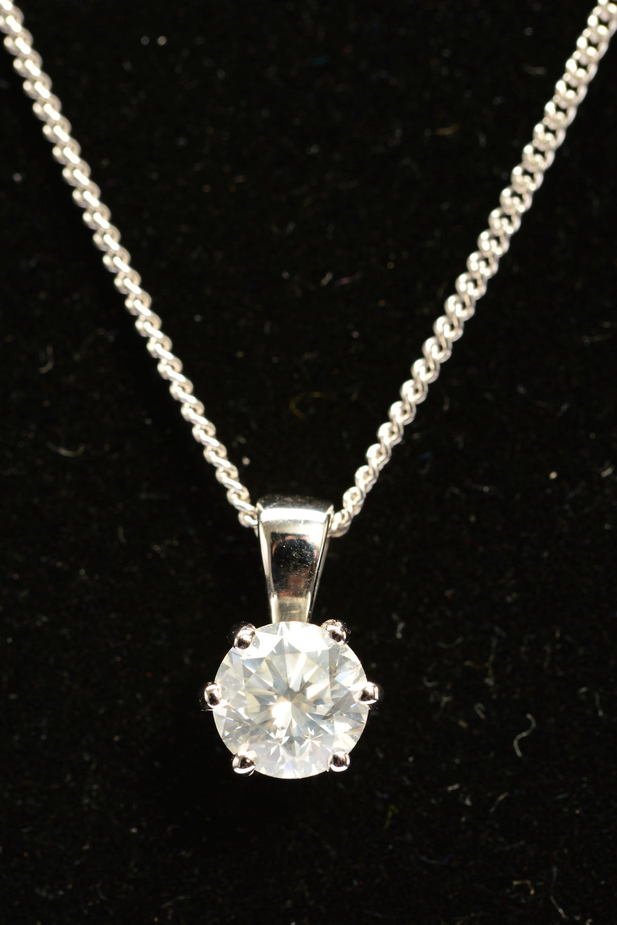 A MODERN SINGLE STONE DIAMOND PENDANT, a modern round brilliant cut diamond, together with an HRD