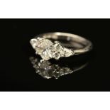 A MODERN PLATINUM DIAMOND DRESS RING, centring on an oval modern brilliant cut diamond,