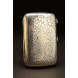 A GEORGE V SILVER RECTANGULAR CIGAR CASE, rounded corners and bowed back, foliate scroll decoration,