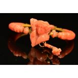 A DELICATE VICTORIAN CARVED CORAL BANGLE, centring on a carved cameo depicting Demeter, suspending a