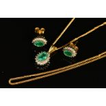 AN EMERALD AND DIAMOND PENDANT AND EARRING SET, the pendant designed with an oval emerald within a
