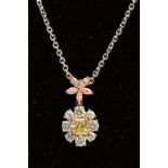 A MODERN DIAMOND FLOWER PENDANT, comprised of a circular yellow and white diamond cluster