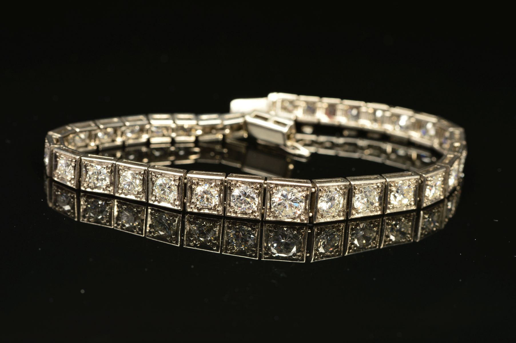 AN ART DECO GRADUATED DIAMOND LINE BRACELET, brilliant cut diamonds, each set to a box setting