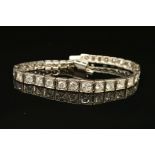 AN ART DECO GRADUATED DIAMOND LINE BRACELET, brilliant cut diamonds, each set to a box setting