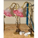 A PAIR OF BRASS ADJUSTABLE TABLE LAMPS, with glass wavy edged shades (one cracked), with carry
