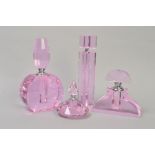 FOUR PINK GLASS MODERN PERFUME BOTTLES, of various shapes and sizes, tallest 23.5cm, smallest 10.5cm