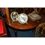 AN EDWARDIAN OAK WIND OUT DINING TABLE, on fluted legs, with three additional leaves, closed