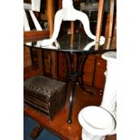 A CIRCULAR GLASS TOPPED TABLE on a seperate wrought iron base, diameter 96cm, together with a