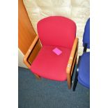 A SET OF TEN OAK FRAMED RED UPHOLSTERED OFFICE ARMCHAIRS (one on show, rest in store)