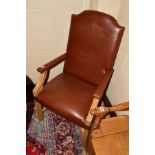 A REPRODUCTION LIGHT OAK GAINSBOROUGH CHAIR with studded brown leather upholstery