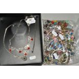 A SELECTION OF CHARMS AND CHARM BRACELETS, to include glass and enamel charms, many bracelets and