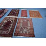 A SILK TEKKE RUG, russet ground, 137cm x 92cm, three early 20th Century red ground rugs and