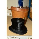 A GENTS TOP HAT, approximate size 52cm, together with a tan leather hat box, stitching coming undone