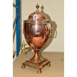 A COPPER SAMOVAR, with brass tap, lion mask ring handles, on four bun feet, approximate height 50cm