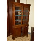 A GEORGIAN MAHOGANY ASTRAGAL GLAZED DOUBLE DOOR CORNER CUPBOARD, painted interior above a double