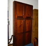 A VICTORIAN STAINED PITCH PINE FOUR DOOR CUPBOARD of narrow proportions, lacking internal hanging