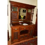 AN EDWARDIAN OAK MIRROR BACK SIDEBOARD, the top with triple bevelled edge mirrors, carved panels