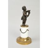 A SMALL BRONZE CHERUB FIGURE, holding a horn shaped shell, on a brass/ceramic plinth, approximate