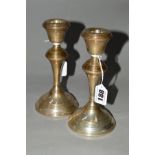 A PAIR OF ELIZABETH II SILVER CANDLESTICKS OF CIRCULAR FORM, concentric band decoration, loaded