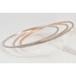 THREE DIAMOND SET BANGLES, all set with a full line of single cut diamonds, in rose metal, yellow