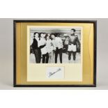 A PHOTOGRAPH OF MUHAMMAD ALI WITH THE BEATLES, signed by Ali on a separate card below the
