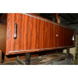 A 1980'S ROSEWOOD FINISH SIDEBOARD with double sliding doors on chrome open ended U shaped legs,