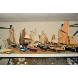 ELEVEN WOODEN MODEL SAILING BOATS OF VARIOUS SIZES, one still in original box, approximate largest
