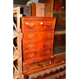 A REPRODUCTION CHERRYWOOD CHEST OF FOUR DRAWERS and a mahogany oval topped coffee table (2)