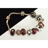 A MODERN RHONA SUTTON CHARM BRACELET, together with various assorted glass and enamelled beads,