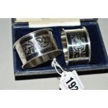 A PAIR OF GEORGE V SILVER NAPKIN RINGS, milled rims, engraved decoration, Chester 1921,