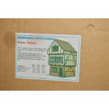 A BOXED FLAT PACK DOLLS HOUSE, Barbaras Mouldings 'Tudor House', three storey timber framed Tudor