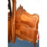 AN EARLY 20TH CENTURY FRENCH WALNUT 4' BED FRAME with foliage and scrolled decoration