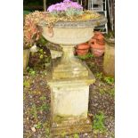 A LARGE CIRCULAR STONE PLANTER, lattice perimeter on a seperate base supported on a square composite