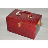 A RECTANGULAR RED CROCODILE SKIN VANITY CASE, carry handle to the top, mirror to interior, lacks