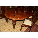 A VICTORIAN WALNUT WIND OUT DINING TABLE, rounded ends, on four large shaped legs with brass caps