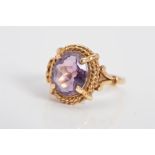 A LATE 20TH CENTURY SINGLE STONE AMETHYST RING, twist rope edge to split shoulder design, amethyst